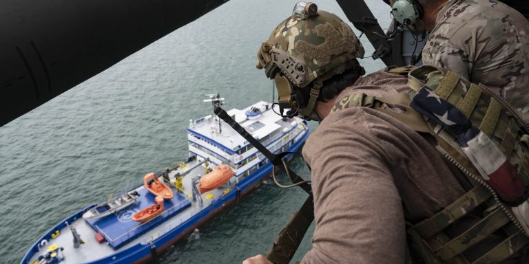 Two U.S. Naval Special Warfare operators spectate a simulated visit, board, search, and seizure training during PANAMAX-Alpha Phase I, at Panama City, Panama, July 16, 2025.