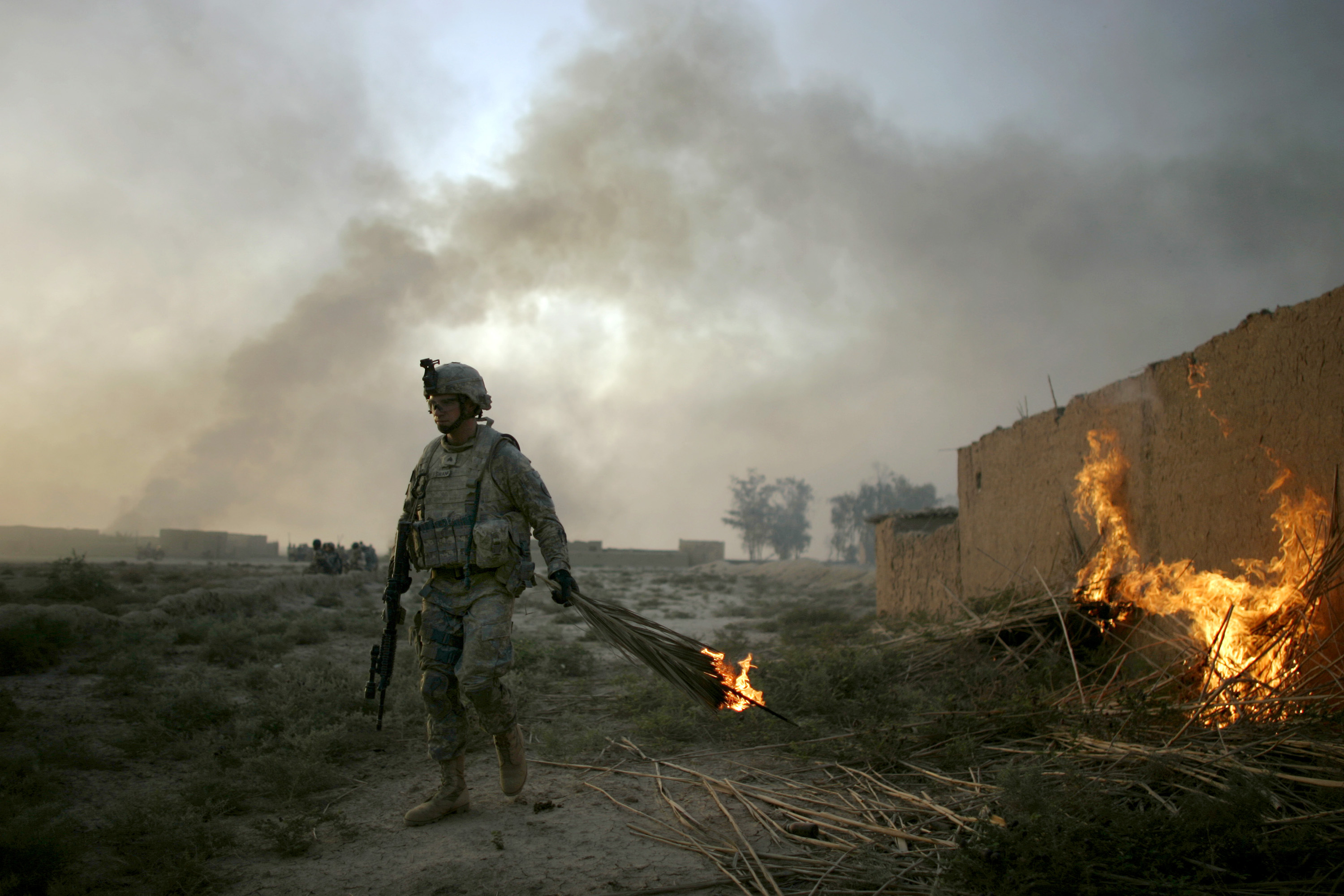 A U.S. army soldier from Fox Troop, Sabre Squadron, 3rd Armored Cavalry Regiment, sets a mud hut on fire in a deserted village on the outskirts of Balad Ruz, in Diyala province, some 75 kilometers ( 46.6 miles) northeast of Baghdad, Iraq, Sunday, Aug. 10, 2008. Soldiers from Fox Troop burned down a deserted village in the area, in order to deny safe haven to possible terrorists in their area of operation. (AP Photo/Marko Drobnjakovic)