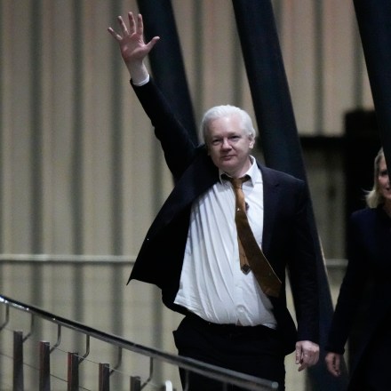WikiLeaks founder Julian Assange waves after landing at RAAF air base Fairbairn in Canberra, Australia, Wednesday, June 26 2024.