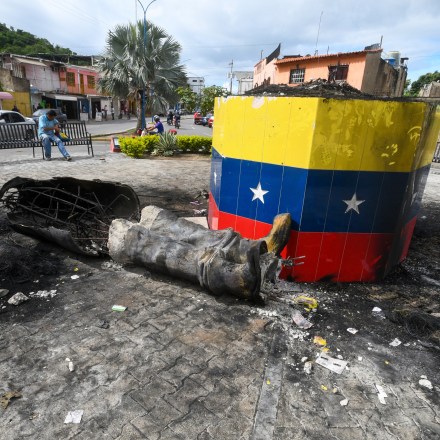 A statue of the late Venezuelan President Hugo Chavez is destroyed in Valencia, Venezuela, Tuesday, July 31, 2024, the day after protests against the official election results that certified Chavez's protege, current President Nicolas Maduro, as the winner.