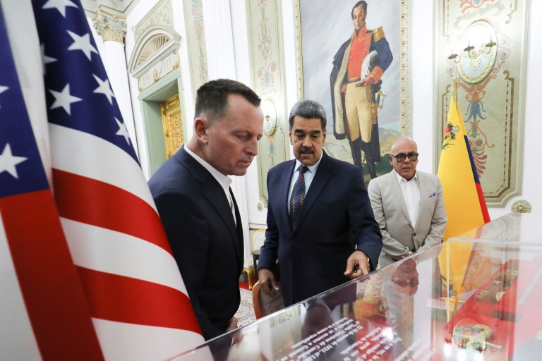 This photo released by Venezuela's presidential press office shows Venezuelan President Nicolas Maduro, center, with Richard Grenell, President Donald Trump's special envoy, left at Miraflores presidential palace in Caracas, Venezuela, Jan. 31, 2025.