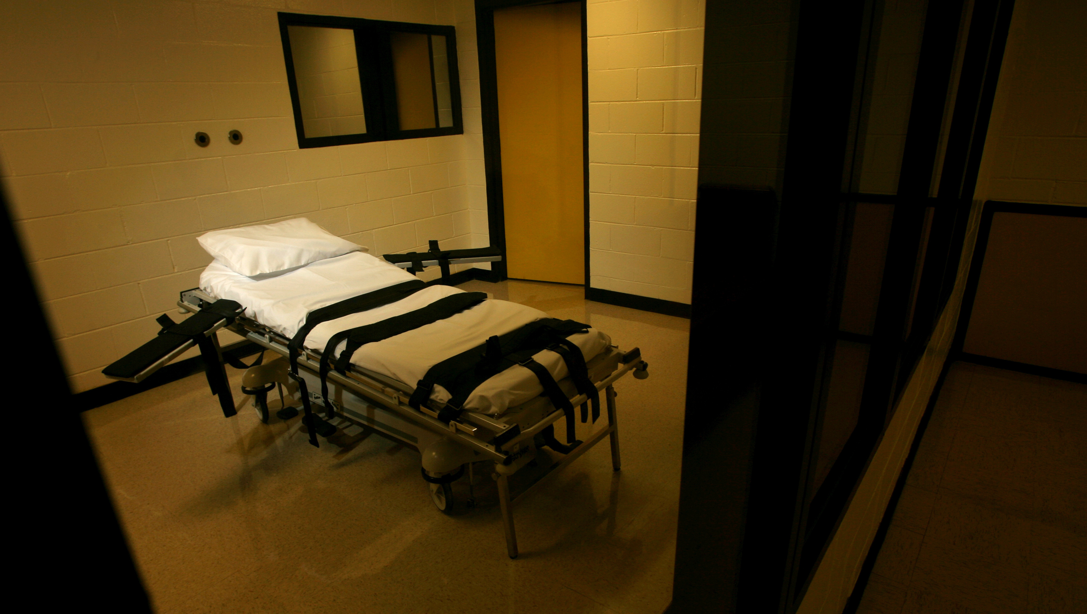 The gurney used for lethal injections sits behind glass windows in a small cinder block building at the Georgia Diagnostic and Classification Prison in Jackson, Ga., Sept. 7, 2007.