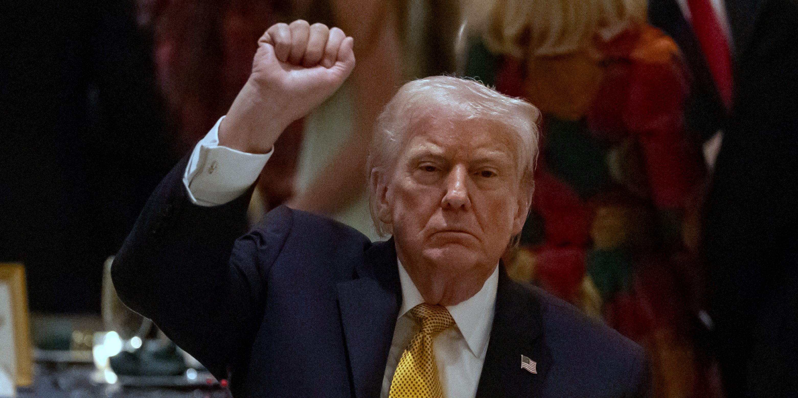 President Donald Trump pumps his fist at Christmas Eve dinner at his Mar-a-Lago club, Wednesday, Dec. 24, 2025, in Palm Beach, Fla.
