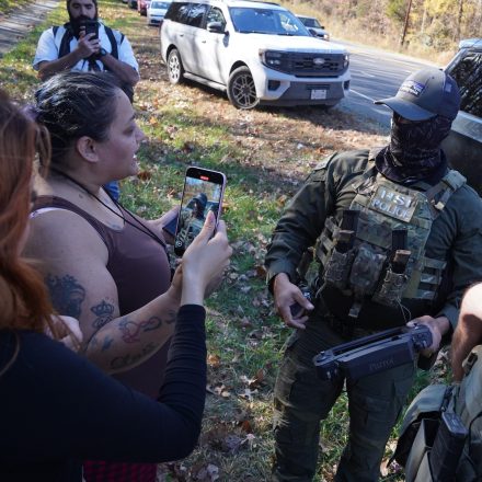 CHARLOTTE, NORTH CAROLINA - NOVEMBER 16: Department of Homeland Security Investigations officers search for two individuals who fled the scene after being stopped while selling flowers on the side of the road on November 16, 2025 in Charlotte, North Carolina. This comes on the second day of "Operation Charlotte's Web," an ongoing immigration enforcement surge across the Charlotte region. (Photo by Ryan Murphy/Getty Images)