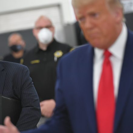 Attorney General William Barr listens to President Donald Trump speak with officials on September 1, 2020, at Mary D. Bradford High School in Kenosha, Wisconsin.