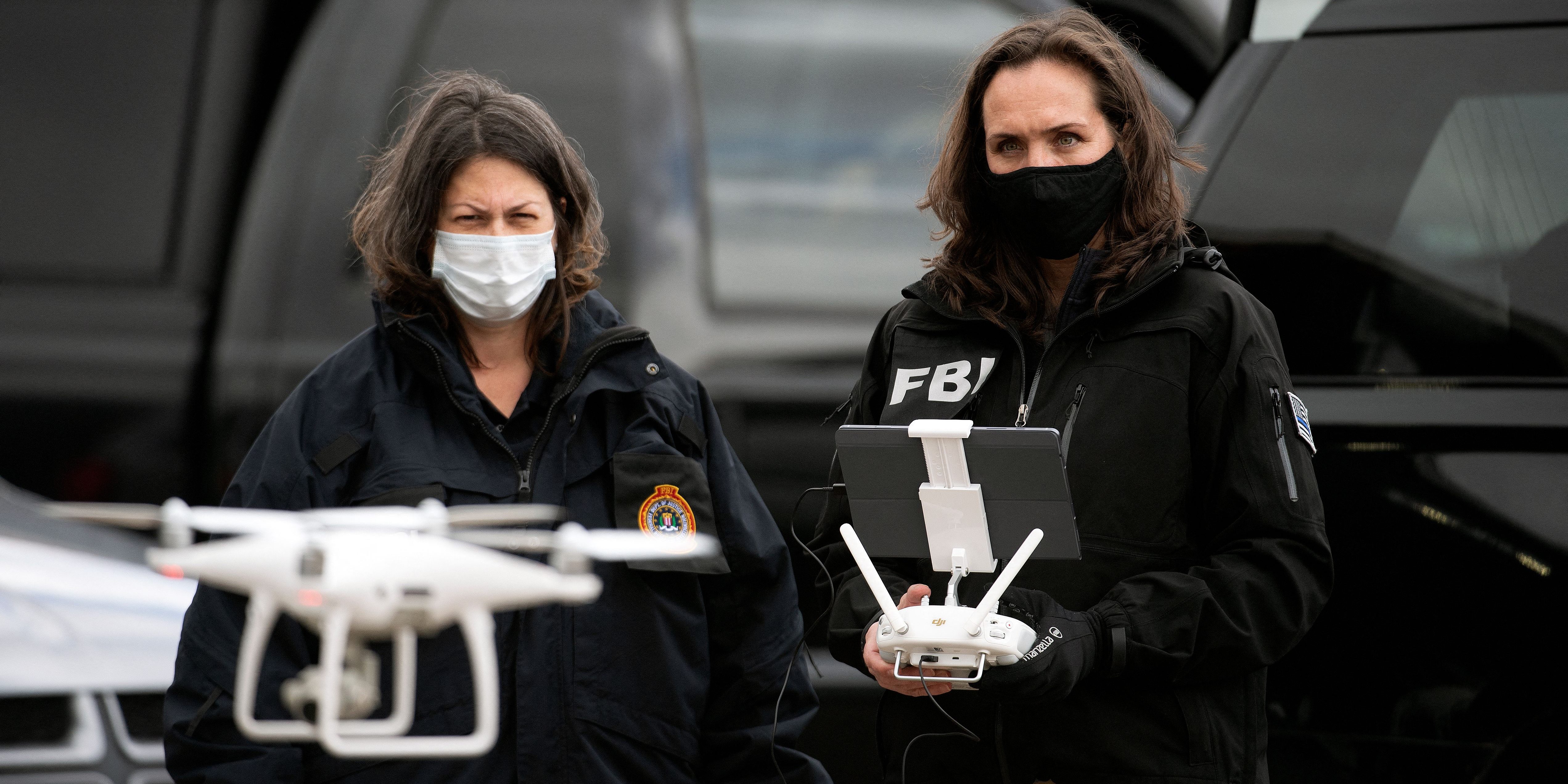 FBI agents prepare to fly a drone at a King Soopers grocery store in Boulder, Colorado on March 23, 2021, one day after a mass shooting left ten dead, including a Boulder police officer. - Colorado police on Tuesday said a 21-year-old man has been charged with 10 counts of murder, a day after a mass shooting at a grocery store in the city of Boulder. "This suspect has been identified as Ahmad Alissa, 21," Boulder Police Chief Maris Herold told a news conference. (Photo by Jason Connolly / AFP) (Photo by JASON CONNOLLY/AFP via Getty Images)