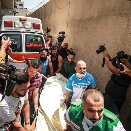 GAZA CITY, GAZA - MAY 11: Palestinians evacuate a building targeted by Israeli warplanes conducting airstrikes in various parts of Gaza Strip, in Gaza City, Gaza on May 11, 2021. Israeli fighters bomb apartment in western Gaza City, kill 3 civilians, several others. (Photo by Mustafa Hassona/Anadolu Agency via Getty Images)