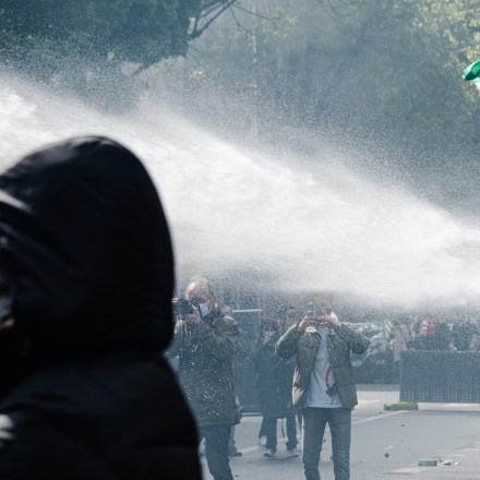 A pro-Palestinian demonstrator carrying a Palestinian flag was shot at by police with a water cannon on 15 May 2021 when, at the call of numerous organisations, a demonstration in support of the Palestinian people was organised in the Barbès district of Paris following the recent tensions in the Middle East between Israel and Palestine, both in the Gaza Strip and the West Bank. Due to fears of outbursts, the march was banned by the Prefecture, creating numerous scenes of violence between demonstrators who had defied the ban and the police who were deployed in large numbers to prevent the slightest beginning of the rally. (Photo by Samuel Boivin/NurPhoto via Getty Images)