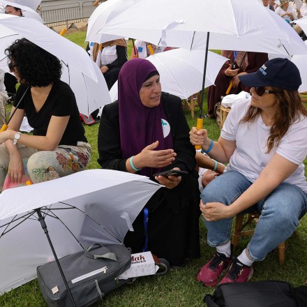 Activists from various local and foreign NGOs gather around the Tolerance Monument in a park in Jerusalem, as they take part in a joint event organised by the Israeli "Women Wage Peace" and the Palestinian "Women of the Sun" movements, demanding an end to the cycle of bloodshed and a solution to the Palestinian-Israeli conflict, on October 4, 2023. (Photo by Menahem KAHANA / AFP) (Photo by MENAHEM KAHANA/AFP via Getty Images)
