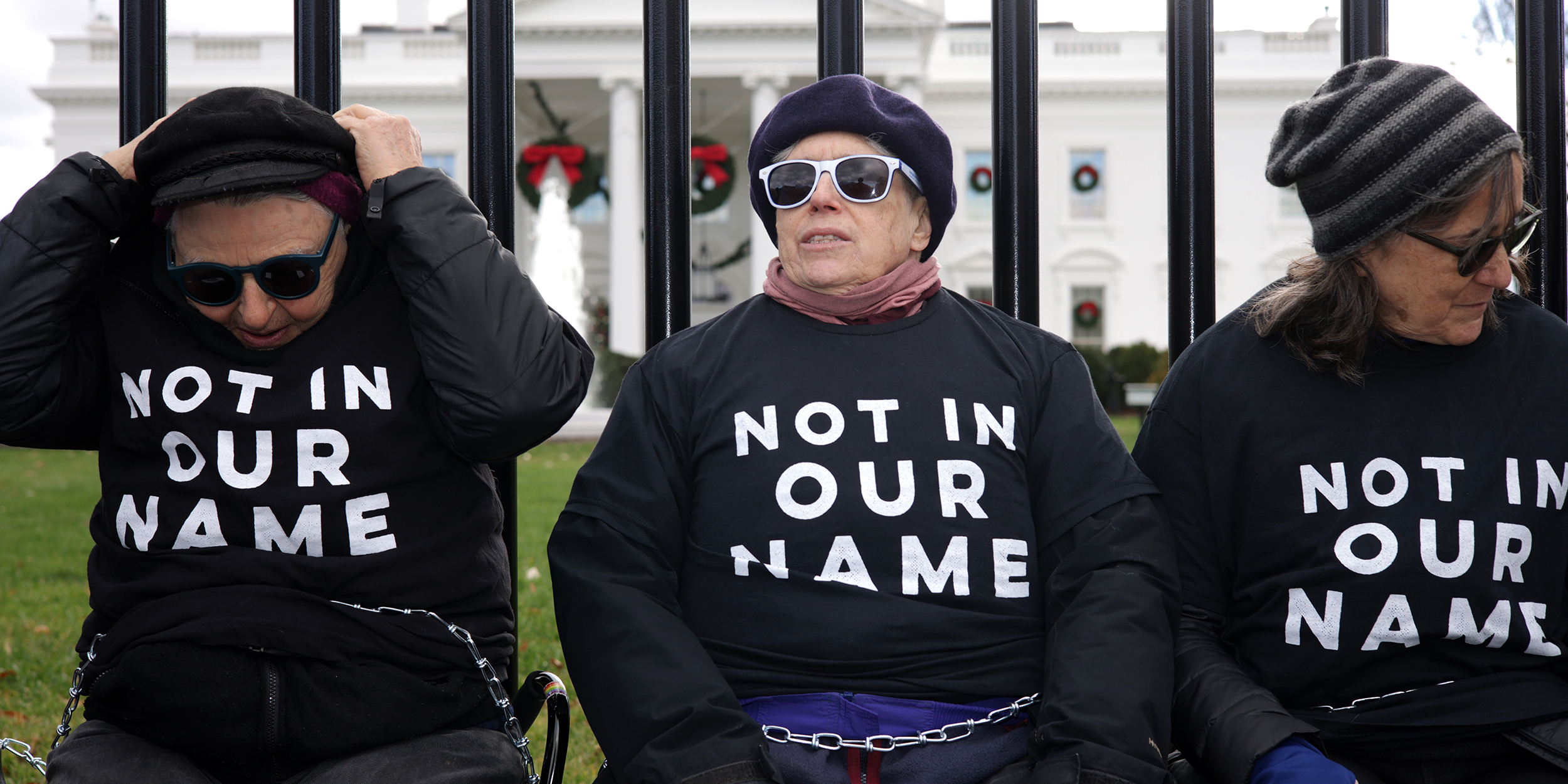 WASHINGTON, DC - DECEMBER 11: Activists chain themselves to the fence of the White House during a protest on the Israel/Hamas war on December 11, 2023 in Washington, DC. Jewish Voice for Peace staged a demonstration to call for an immediate ceasefire of the conflict. (Photo by Alex Wong/Getty Images)