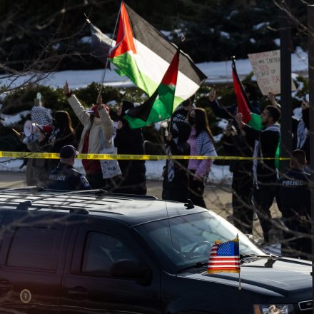 Pro-Palestinian demonstrators stand outside George Mason University in Manassas, Virginia on Jan. 23, 2024, as US President Joe Biden's motorcade arrives for a rally.