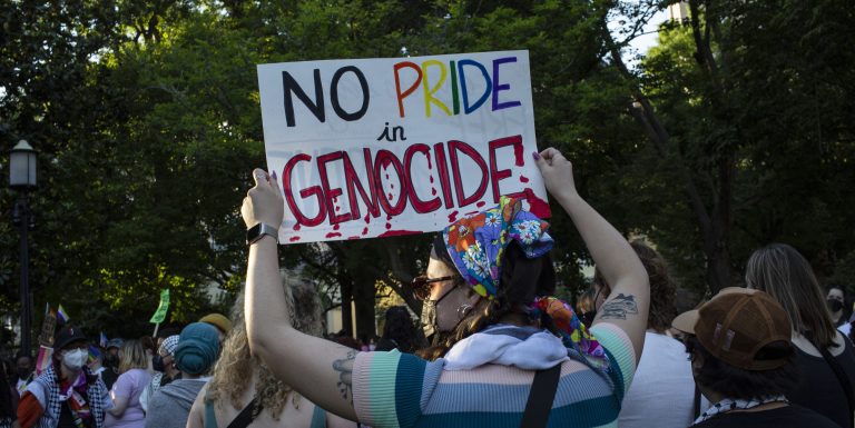 WASHINGTON, DISTRICT OF COLUMBIA, UNITED STATES - 2024/06/07: An activist holding a sign with No Pride in Genocide is written on it while joining in the Dyke March. Lesbian activists taking part in the Dyke March, gathered at Lafayette Square near the White House and then march to Dupont Circle in Washington DC. The Dyke March always protests corporatization of Pride, but this year's theme was Dykes Against Genocide. (Photo by Probal Rashid/LightRocket via Getty Images)