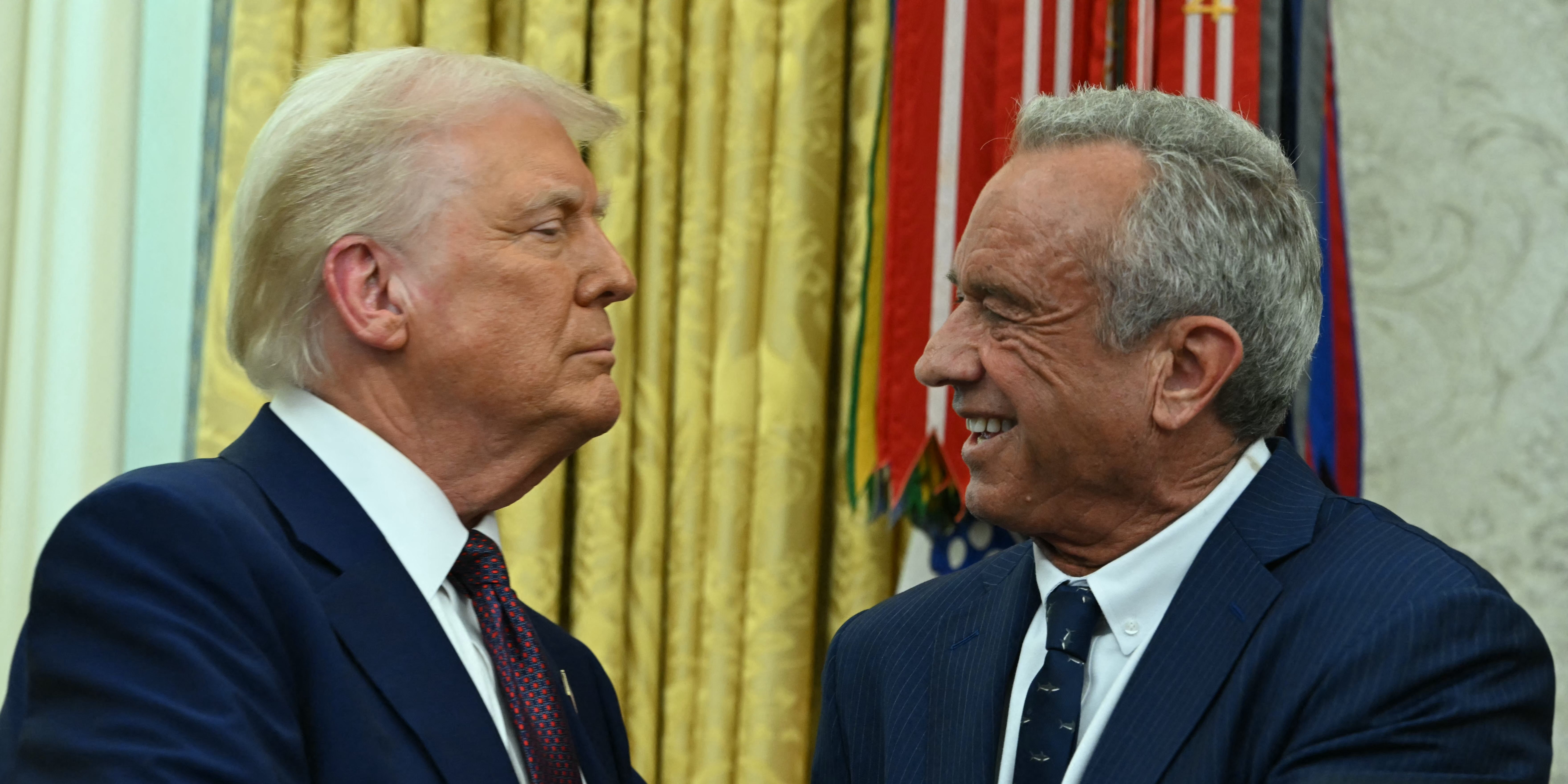 The new US Secretary of Health and Human Services Robert F. Kennedy Jr., shakes hands with US President Donald Trump after a swearing in ceremony in the Oval Office of the White House in Washington, DC, on February 13, 2025. (Photo by ANDREW CABALLERO-REYNOLDS / AFP) (Photo by ANDREW CABALLERO-REYNOLDS/AFP via Getty Images)