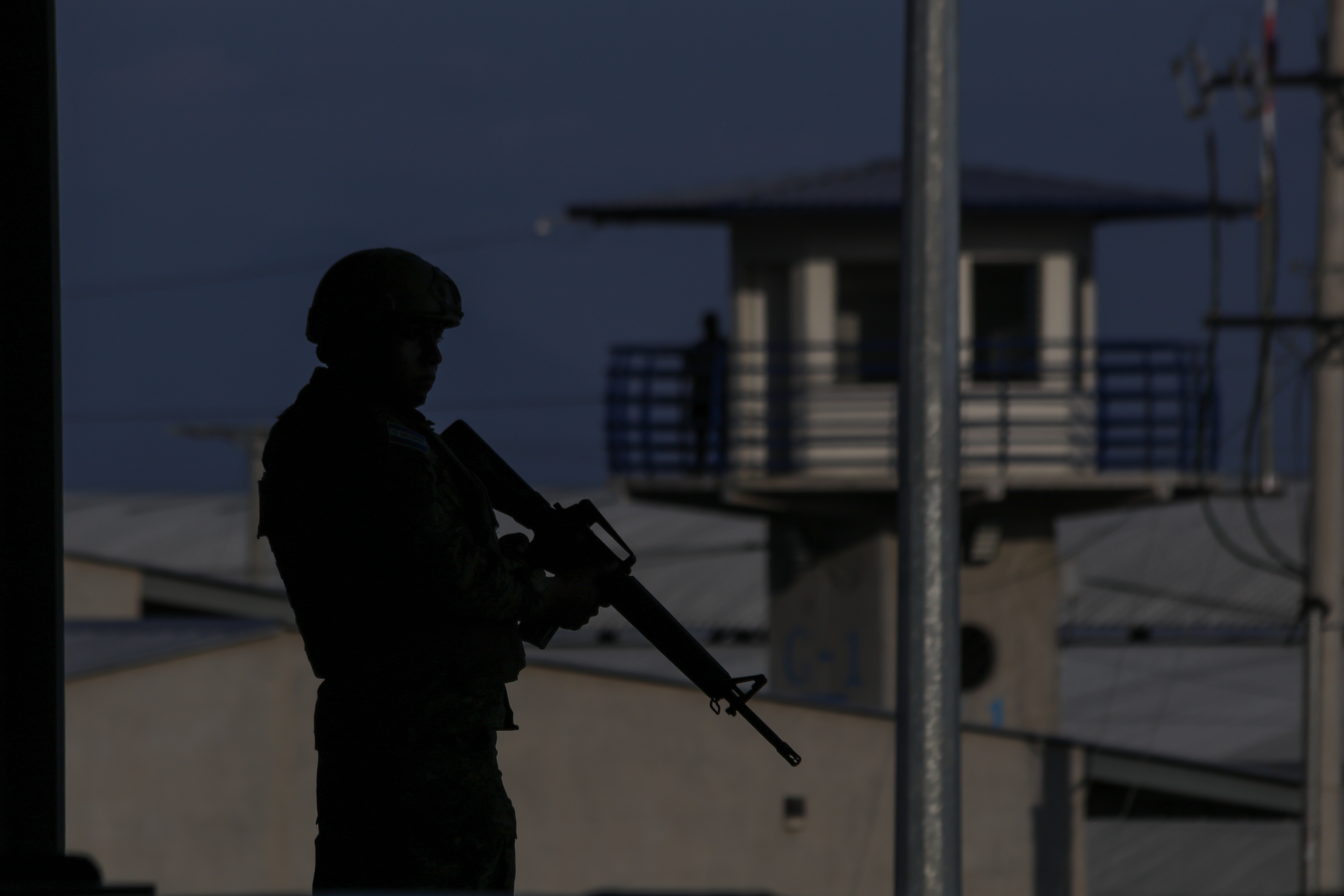 SAN VICENTE, EL SALVADOR - APRIL 04: Soldiers guarding with rifles at the Terrorism Confinement Center (CECOT) in Tecoluca, in San Vicente, El Salvador on April 04, 2025. The Cecot prison was presented to Salvadorans by President Nayib Bukele on national radio and television as the largest prison in the Americas, built for members of the Mara Salvatrucha (MS 13) gang and the two Barrio 18 groups (Sureña and Revolucionaria). Following the deportation of hundreds of migrants from the United States to El Salvador, it became a resource for the Donald Trump administration in implementing its immigration policy. (Photo by Alex Pena/Anadolu via Getty Images)