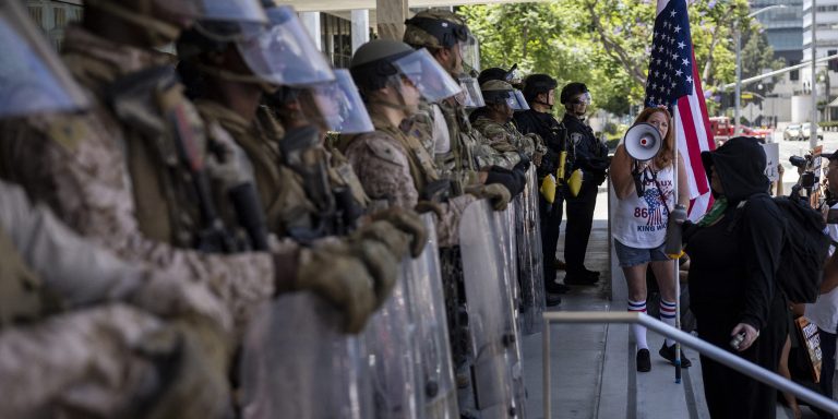 Demonstrators gather in front of the Federal building guarded by a mix of US marines and National guards during the "No Kings" protest following federal immigration operations, in Los Angeles, California on July 4, 2025. According to Immigration and Customs Enforcement (ICE) figures obtained by the Deportation Data Project, which collects US immigration enforcement data, 722 migrants were arrested in Los Angeles and the surrounding area from June 1 to 10. (Photo by ETIENNE LAURENT / AFP) (Photo by ETIENNE LAURENT/AFP via Getty Images)