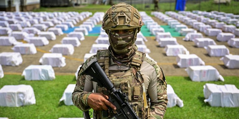 A Panamanian National Aeronaval Service officer guards 12 tons of cocaine divided into hundreds of packages at the Aeronaval headquarters in Panama City on November 11, 2025. Panama carried out one of the largest drug seizures in its history after intercepting about 12 tons of cocaine on a vessel in the Pacific that was bound for the United States, local authorities said on November 11, 2025. (Photo by Martin BERNETTI / AFP) (Photo by MARTIN BERNETTI/AFP via Getty Images)