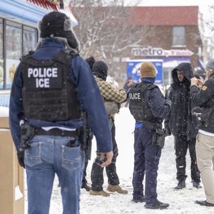 MINNESOTA, UNITED STATES - DECEMBER 10:  Immigrations, Customs, and Enforcement officers question a man's status on Lake Street near a Somali mall called the Karmel Mall in Minnesota, United States on December 10, 2025. They questioned him as activists and ICE agents confronted each other. (Photo by Christopher Juhn/Anadolu via Getty Images)