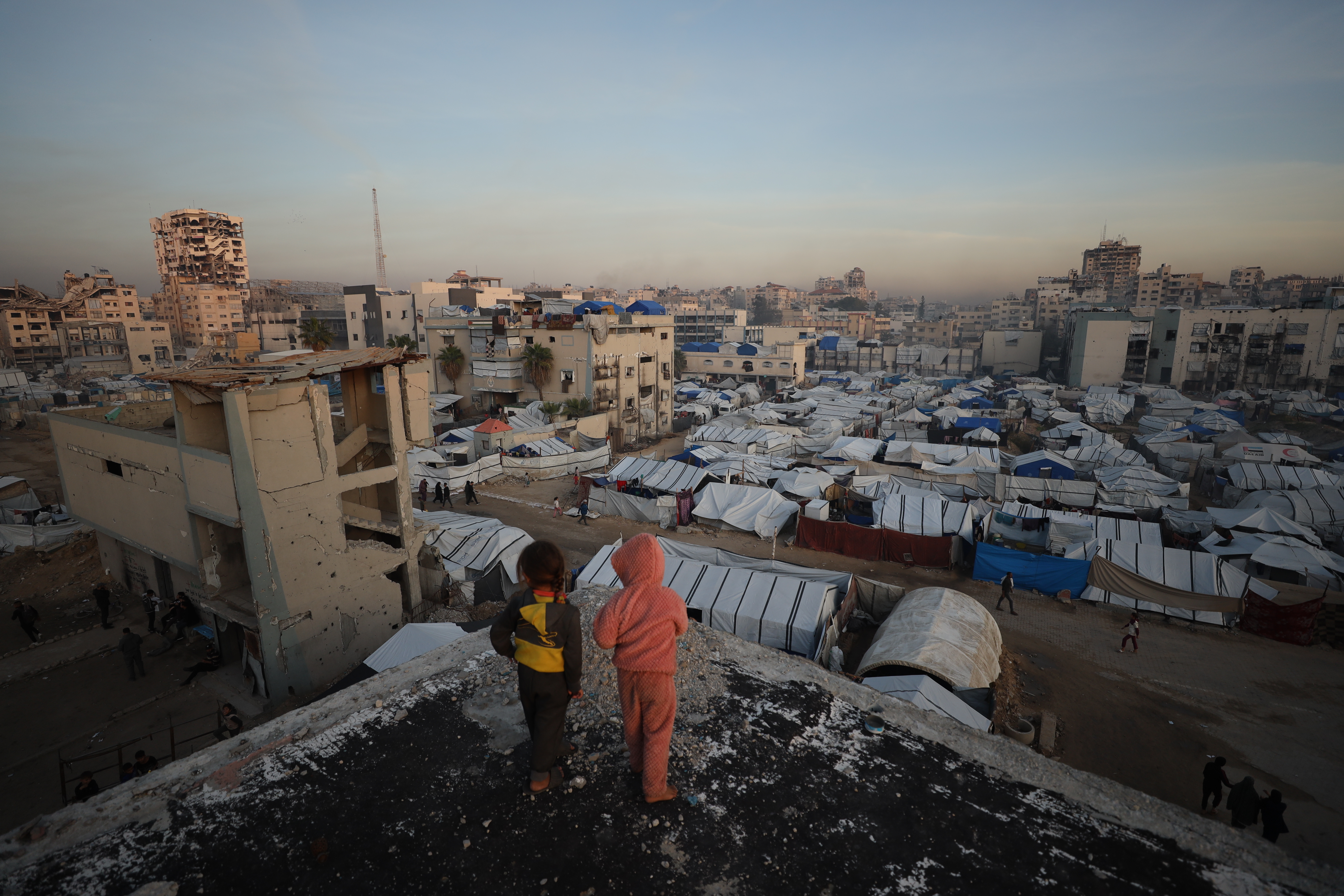 GAZA CITY, GAZA - DECEMBER 22: Many displaced Palestinians struggle to maintain their daily lives under harsh conditions amid the rubble left by Israeli attacks in Gaza City, Gaza on December 22, 2025. Lacking basic necessities, families cling to life in makeshift tents set up near their destroyed homes while battling cold weather conditions. (Photo by Khames Alrefi/Anadolu via Getty Images)