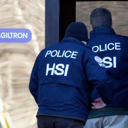 Agents from the U.S. Immigration and Customs Enforcement's Homeland Security Investigations (HSI) unit enter the offices of Agiltron in Woburn, Massachusetts, U.S., on Wednesday, Jan. 23, 2013. Agiltron describes itself as providing clients with "optical communication and sensing solutions" on the company website. Photographer: Bizuayehu Tesfaye/Bloomberg via Getty Images