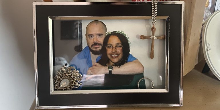 A framed wedding photograph of Tahina Corcoran and her husband Joe Corcoran sits on a dresser in Tahina’s bedroom at her home in Indiana.