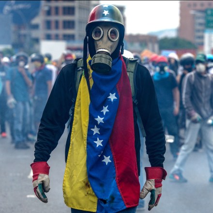TOPSHOT - Opposition activists protest against President Nicolas Maduro, in Caracas on May 8, 2017.Venezuela's opposition mobilized Monday in fresh street protests against President Nicolas Maduro's efforts to reform the constitution in a deadly political crisis. Supporters of the opposition Democratic Unity Roundtable (MUD) gathered in eastern Caracas to march to the education ministry under the slogan "No to the dictatorship." / AFP PHOTO / FEDERICO PARRA (Photo credit should read FEDERICO PARRA/AFP/Getty Images)